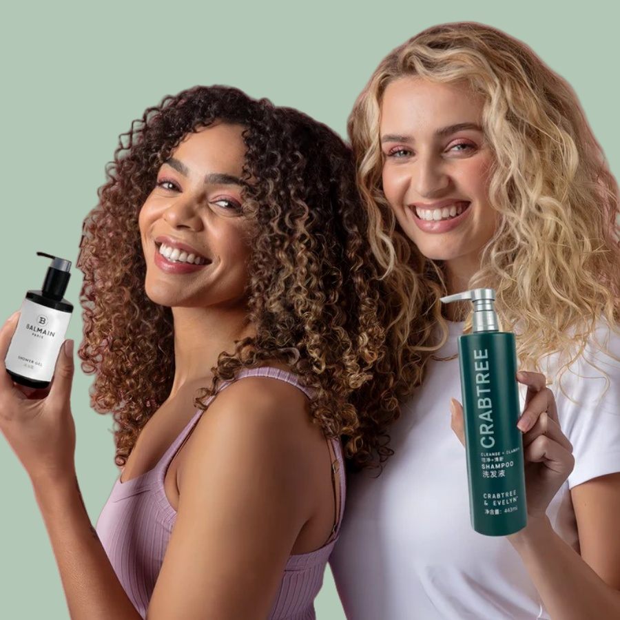 two girls take 2 toiletries and smaile